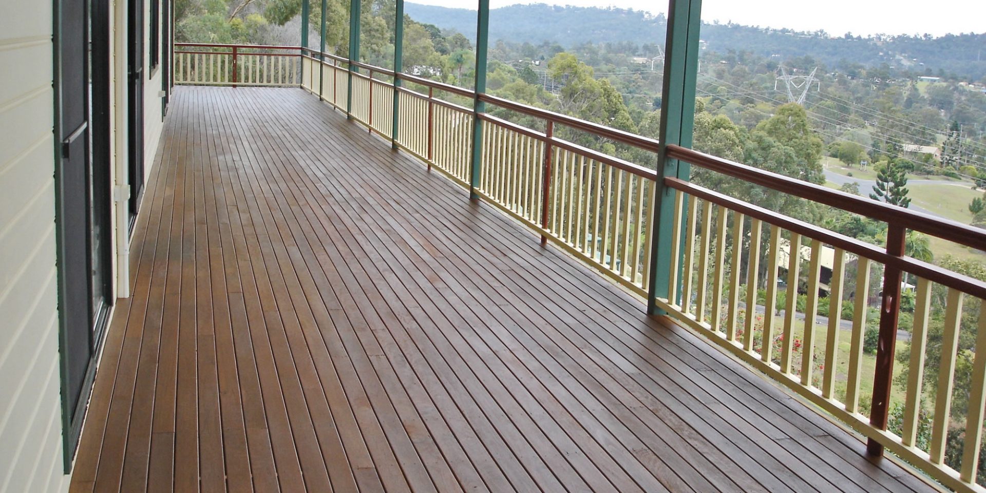 Timber balcony of house looking out to fields