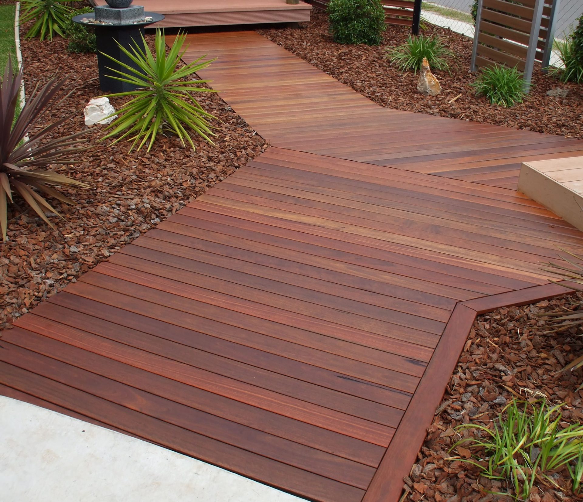 Dark timber path in courtyard