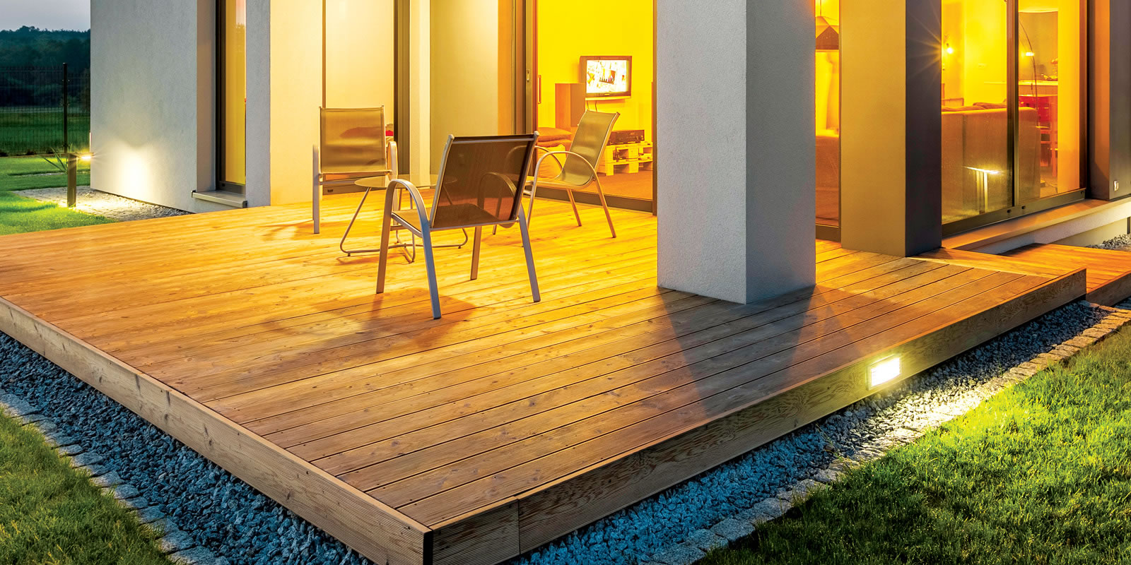 Backyard timber deck surrounded by grass